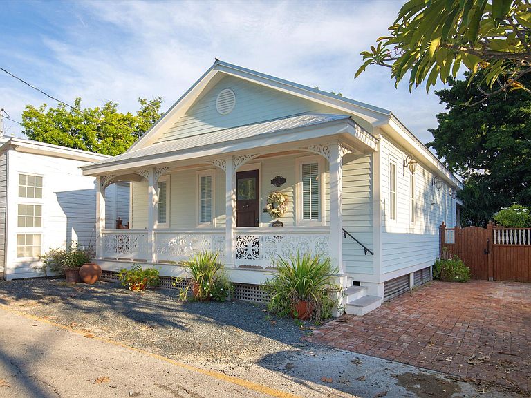 Historic Key West cottage exterior with gingerbread trim and covered porch