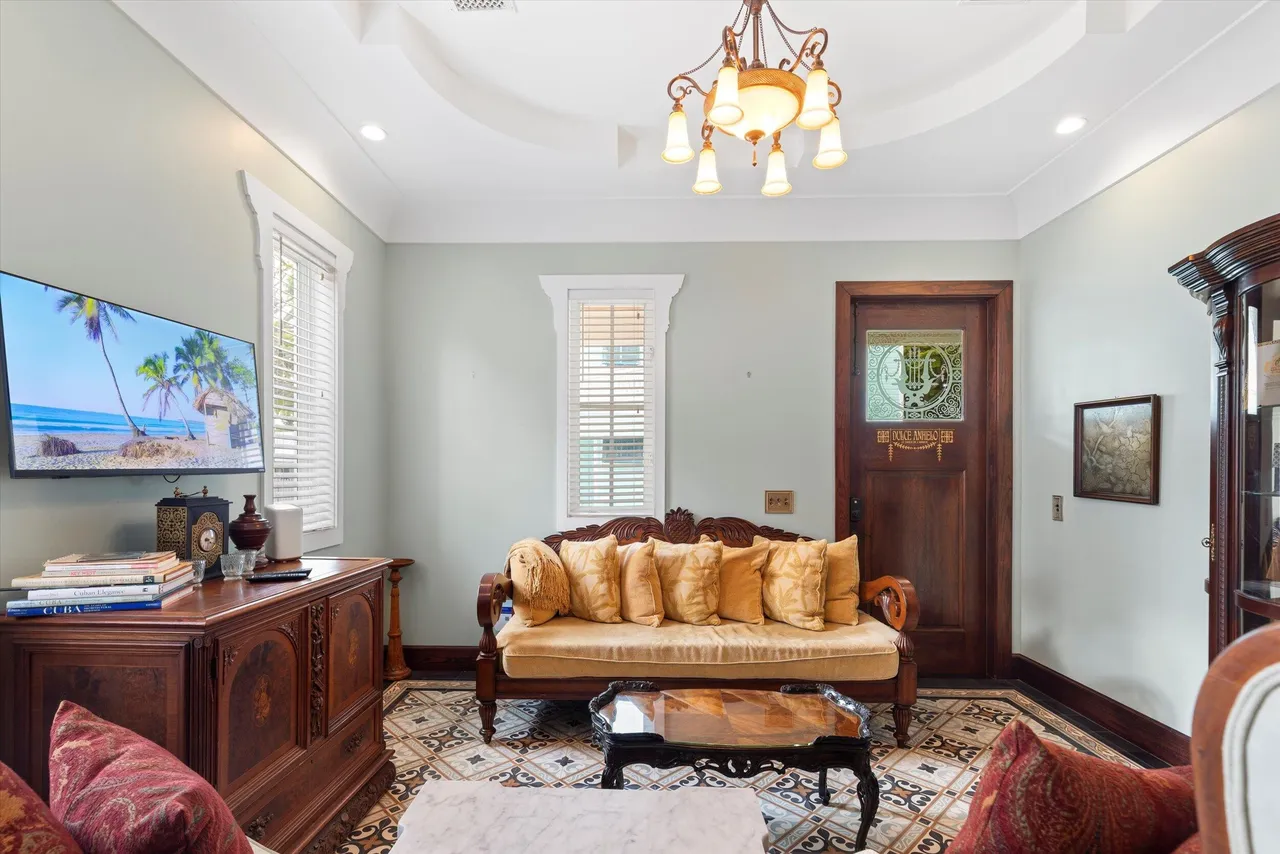 Elegant living room with antique furnishings and patterned tile floor