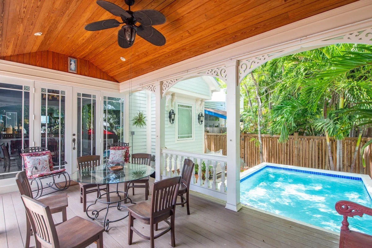 Covered patio and private pool viewed from the backyard