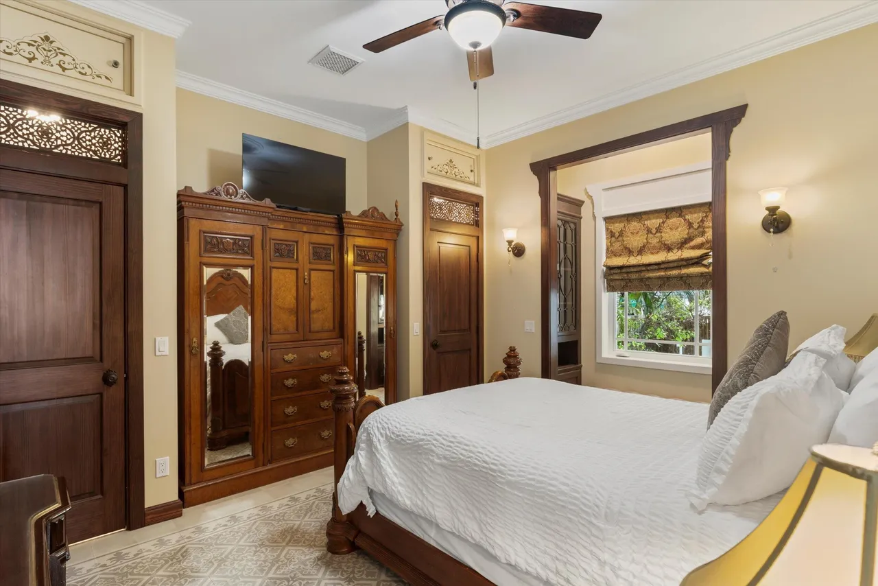 Bedroom with antique wood armoire, king bed and Key West charm