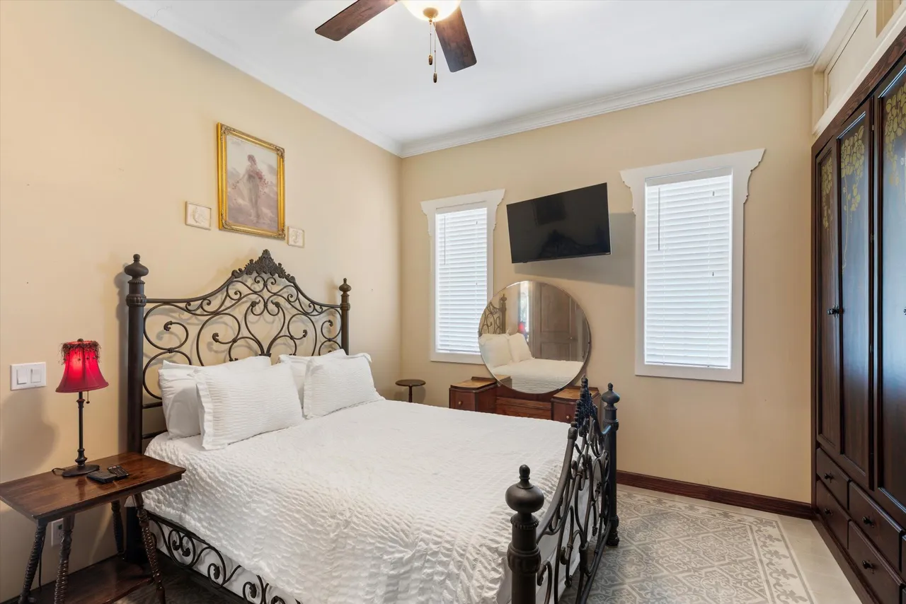Bedroom with ornate wrought-iron bed frame and vintage decor